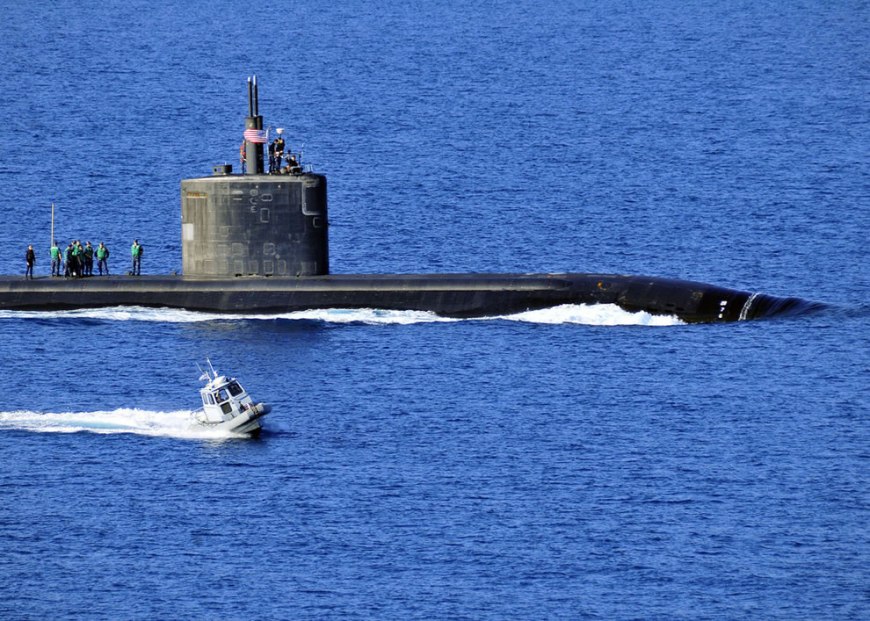 A harbor security boat escorts the Los Angeles-class attack submarine USS Annapolis (SSN 760) as the ship departs Souda Bay, Crete