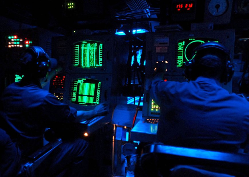 U.S. Navy sonar technicians aboard the guided-missile destroyer USS The Sullivans (DDG 68) monitor sonar equipment for marine mammals or submarine activity during the Southeastern Anti-Submarine Warfare Integrated Training Initiative in the Atlantic Ocean